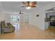 Spacious living room featuring tile flooring and natural light with an armchair at 1674 Cottonwood Trl, Sarasota, FL 34232