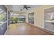 Relaxing screened-in patio with ceiling fan, tile floors, and natural light at 1674 Cottonwood Trl, Sarasota, FL 34232