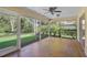 Cozy sunroom with screened windows and access to the beautifully landscaped backyard at 1674 Cottonwood Trl, Sarasota, FL 34232