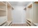 Walk-in closet with wood floors and custom shelves and storage at 1674 Cottonwood Trl, Sarasota, FL 34232