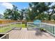 Back deck overlooking a fenced-in yard with mature trees and a small shed at 1911 26Th W St, Bradenton, FL 34205