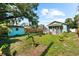 A large backyard featuring a shed, green grass, and plenty of space for outdoor activities at 1911 26Th W St, Bradenton, FL 34205