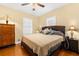 Cozy bedroom featuring a ceiling fan, bedside lamps, and hardwood floors at 1911 26Th W St, Bradenton, FL 34205