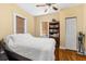 A cozy bedroom featuring hardwood floors, a ceiling fan, and a built-in bookshelf at 1911 26Th W St, Bradenton, FL 34205