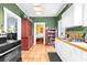 Charming kitchen featuring white cabinets, vintage accents, and a view to the living area at 1911 26Th W St, Bradenton, FL 34205