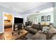 Comfortable living room features a large TV, an open floorplan, and a view to the bedroom at 1911 26Th W St, Bradenton, FL 34205