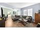 Inviting living room featuring hardwood floors, a large sectional sofa, and an open layout with ample natural light at 1911 26Th W St, Bradenton, FL 34205