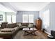 Spacious living room with a sectional sofa, neutral walls, and natural light, creating a comfortable and inviting space at 1911 26Th W St, Bradenton, FL 34205