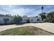The house features a white exterior, big windows, and a circular driveway at 205 55Th Ave, St Pete Beach, FL 33706