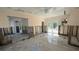 A living room is under renovation, showing exposed studs and flooring at 205 55Th Ave, St Pete Beach, FL 33706