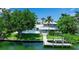 Beautiful backyard featuring a dock, swimming pool and well-maintained lawn at 259 S Polk Dr, Sarasota, FL 34236