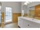 Bathroom featuring a double vanity, yellow tile, and a walk-in shower with glass door at 259 S Polk Dr, Sarasota, FL 34236