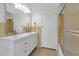 This bathroom features a double sink with white cabinets and yellow tile accents at 259 S Polk Dr, Sarasota, FL 34236