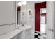 A vibrant bathroom with a classic vanity, hair dryers, and black and white checkered floors at 259 S Polk Dr, Sarasota, FL 34236