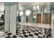 Unique bathroom features a checkered floor, a mirrored wall, and updated fixtures at 259 S Polk Dr, Sarasota, FL 34236
