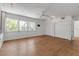 Bright bedroom featuring hardwood floors, three windows, and a ceiling fan for optimal comfort at 259 S Polk Dr, Sarasota, FL 34236
