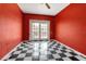 Bright bedroom with eye-catching checkered floors and glass paneled double doors at 259 S Polk Dr, Sarasota, FL 34236