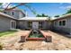 Stunning courtyard entrance with water feature, stone pavers, and double doors at 259 S Polk Dr, Sarasota, FL 34236