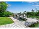 Waterfront property featuring a private wooden dock with boat lift and beautiful canal views at 259 S Polk Dr, Sarasota, FL 34236