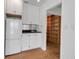 Compact kitchen with white appliances, modern countertops, and convenient built-in cabinets at 259 S Polk Dr, Sarasota, FL 34236