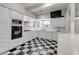 Classic black and white kitchen featuring checkered floors, white cabinets, and modern appliances for a timeless appeal at 259 S Polk Dr, Sarasota, FL 34236