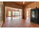 Expansive living room with tiled floor and wood-paneled walls, open floor plan to other rooms, perfect for entertaining at 259 S Polk Dr, Sarasota, FL 34236