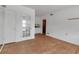 Open living room with wood floors, leading to the kitchen through glass french doors at 259 S Polk Dr, Sarasota, FL 34236