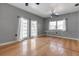 Bright living room featuring wood floors, light gray walls, white trim, and glass patio doors at 259 S Polk Dr, Sarasota, FL 34236