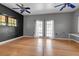 Bright living room featuring wood floors, light gray walls, white trim, and glass patio doors at 259 S Polk Dr, Sarasota, FL 34236