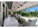 Relaxing outdoor seating area on covered patio with waterfront views and tropical foliage at 259 S Polk Dr, Sarasota, FL 34236