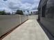 View down the side yard of the property to the backyard, bordered by a white fence at 2606 29Th Ave W # 12, Bradenton, FL 34205