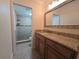Bathroom featuring granite countertops, wooden cabinets, and a tiled shower at 2606 29Th Ave W # 12, Bradenton, FL 34205