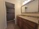 Bathroom vanity with granite countertops, framed mirror, and tiled shower at 2606 29Th Ave W # 12, Bradenton, FL 34205