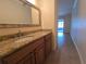 Bathroom vanity with granite countertops, framed mirror, and tile floor at 2606 29Th Ave W # 12, Bradenton, FL 34205