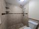 Bathroom with a neutral-tiled shower and a toilet at 2606 29Th Ave W # 12, Bradenton, FL 34205