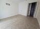 Bedroom with neutral tile flooring, closet space, and ample wall space for decor at 2606 29Th Ave W # 12, Bradenton, FL 34205