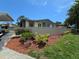 The house exterior is well-landscaped with lush greenery and wood mulch at 2606 29Th Ave W # 12, Bradenton, FL 34205