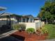 Charming exterior view of a well-maintained property, featuring a freshly mulched garden area and a light beige privacy fence at 2606 29Th Ave W # 12, Bradenton, FL 34205