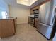 Beautiful kitchen with stainless steel appliances, granite countertops, and tile flooring, providing a modern and functional cooking space at 2606 29Th Ave W # 12, Bradenton, FL 34205