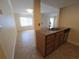 Open-concept view showing the granite countertops in the kitchen with stainless steel dishwasher, connected to living room at 2606 29Th Ave W # 12, Bradenton, FL 34205