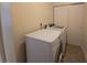 White washer and dryer sit beneath hanging closet in the laundry room at 2606 29Th Ave W # 12, Bradenton, FL 34205
