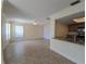 Inviting living room with neutral tile flooring, light walls, and an adjacent open kitchen area at 2606 29Th Ave W # 12, Bradenton, FL 34205