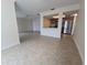Spacious open-concept living area with tile flooring seamlessly connecting to the kitchen, creating a modern and inviting living space at 2606 29Th Ave W # 12, Bradenton, FL 34205