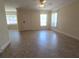Spacious living room with neutral paint, tiled floors, and plenty of natural light at 2606 29Th Ave W # 12, Bradenton, FL 34205