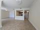 Open-concept living space with a view into the kitchen, featuring tile flooring and neutral colors at 2606 29Th Ave W # 12, Bradenton, FL 34205
