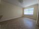 Bright living room area featuring a large window for natural light and neutral tile flooring at 2606 29Th Ave W # 12, Bradenton, FL 34205