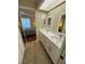 Bathroom featuring a double sink vanity, hardwood floors and ensuite view to the bedroom at 3810 75Th W St # 137, Bradenton, FL 34209