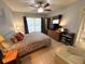 Comfortable bedroom featuring a large window, ceiling fan, and dresser at 3810 75Th W St # 137, Bradenton, FL 34209