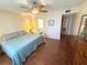 Bedroom with hardwood floors, ensuite bath and ceiling fan at 3810 75Th W St # 137, Bradenton, FL 34209