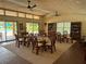 A sunlit clubhouse features seating, a pool view, and charming decor, perfect for community gatherings and relaxation at 3810 75Th W St # 137, Bradenton, FL 34209